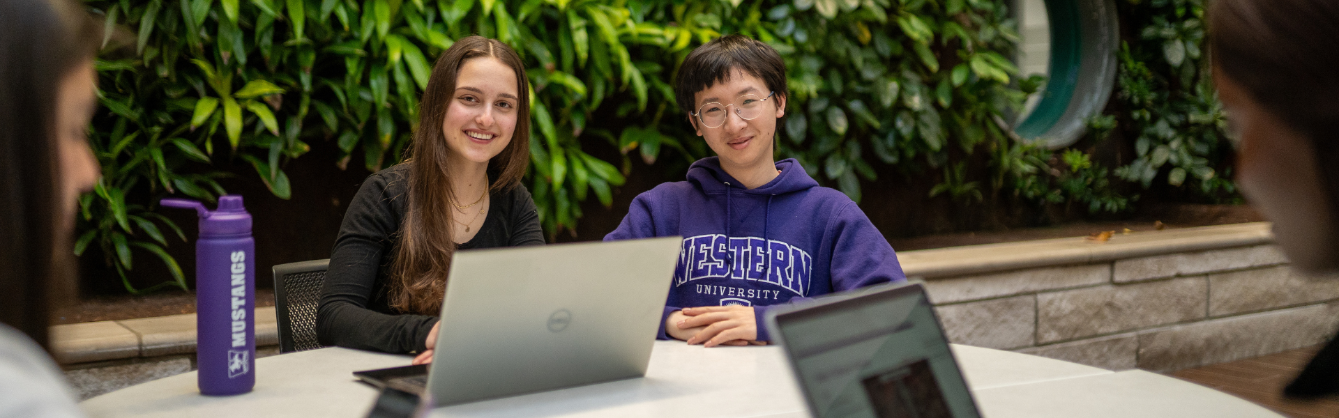 Two students sitting at a table in Thames Hall
