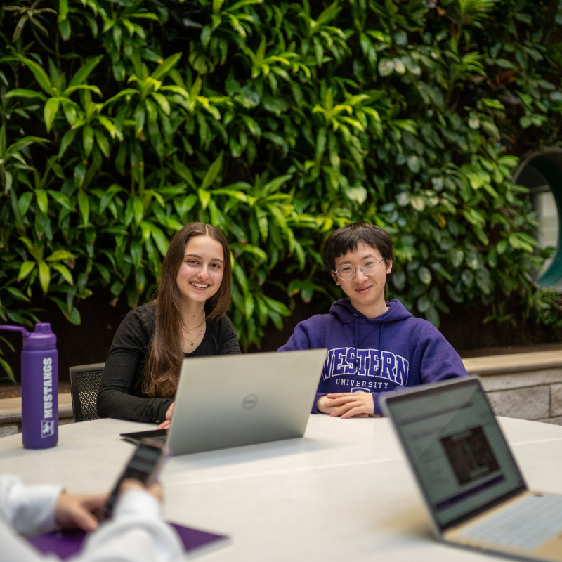 Two students sitting at a table in Thames Hall