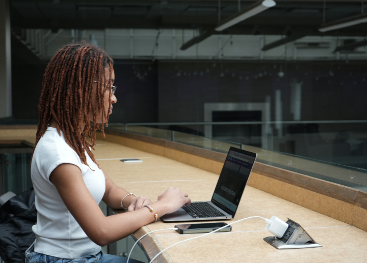 A student typing on a laptop