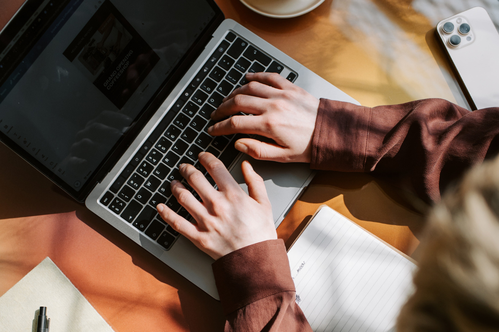 Hands working on a laptop