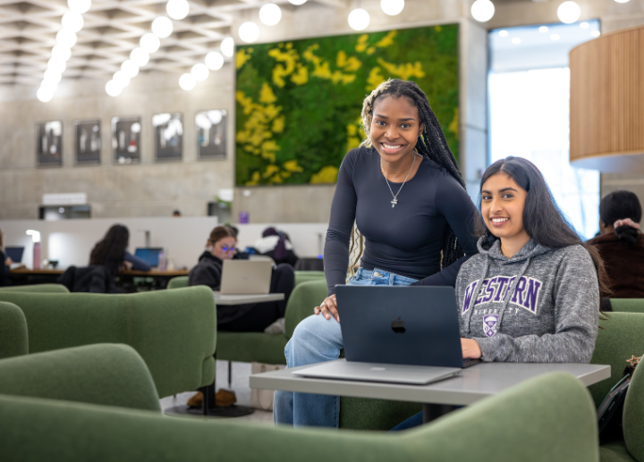 A pair of students sitting together at a table studying