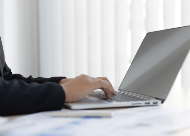 Hands typing at a computer