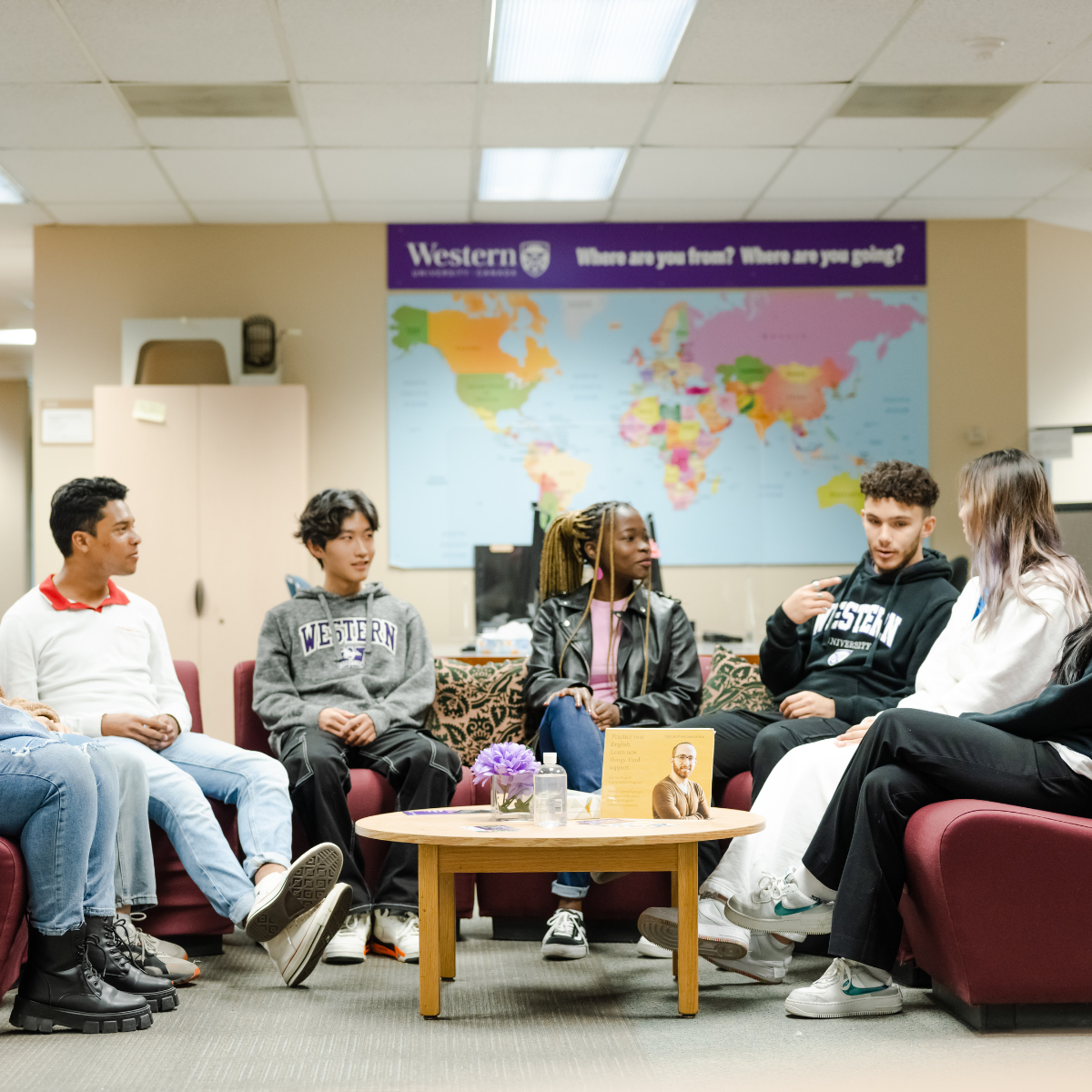 A group of students sitting in a group in the International Student Services Center